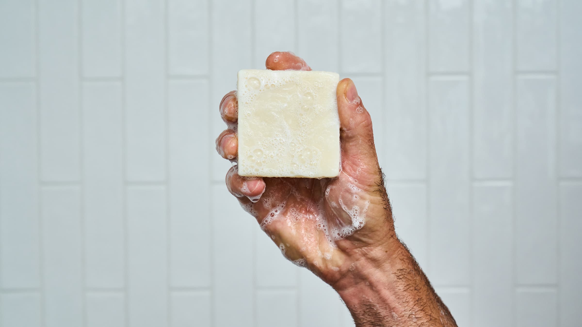 Dr. Squatch Shea Butter bar soap being used